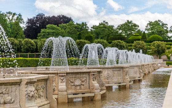 a row of fountains spraying water