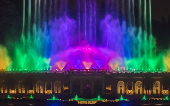a vibrant fountain show with water splashing in a rainbow of colors 