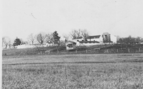 a black and white photo of a farm 