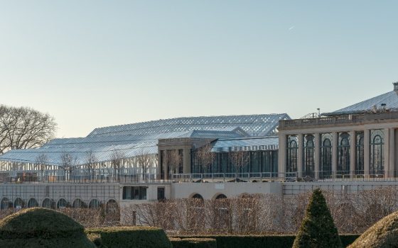 View of the exteriors of the East and West Conservatories as seen through the top of the topiary garden. 