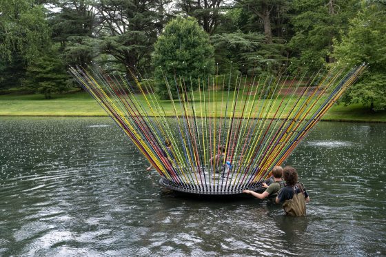 guiding a sculpture of fishing rods in place in a lake