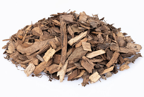 a handful of brown wood chips on a white background