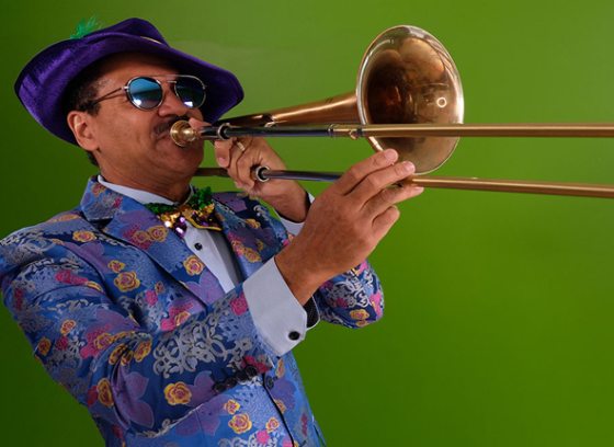 An adult playing the trombone.