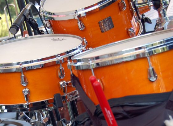 closeup of trio of orange drums in a drumset