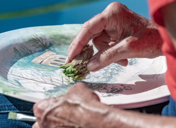 A persons hands creating a watercolor image at Longwood Gardens.