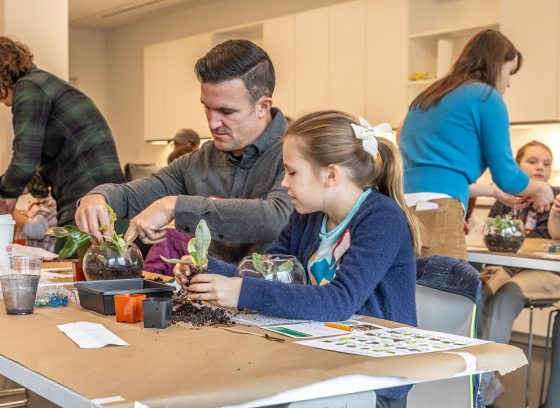 Father and daughter planting a terrarium 