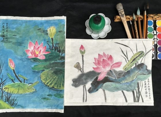 Two waterlily paintings side-by-side with artist's supplies: ink, brushes, watercolor paints.