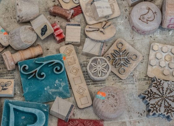 A variety of holiday stamps laying on a work table.