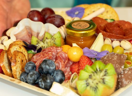 A charcuterie board, fully assembled, on a table.