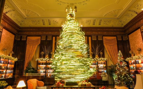 A spinning Chirstmas tree captured with a long-exposure making light trails in a circular motion