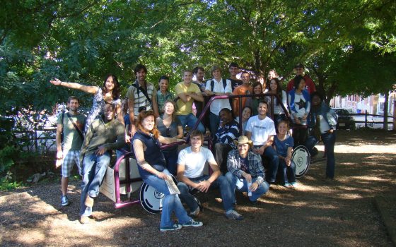 large group of people posing for a photograph outdoors 