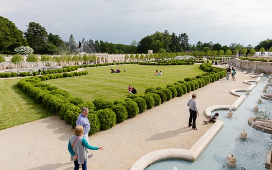 numerous people walking along the paths alongside the Main Fountain Garden at Longwood Gardens