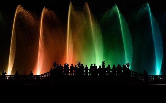 fountains illuminated in rainbow of colors 