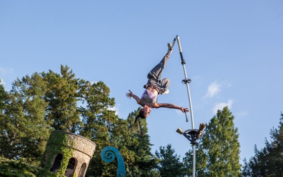a person in the air with their foot attached to a pole 