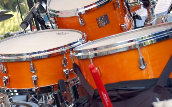 closeup of trio of orange drums in a drumset