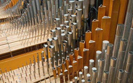 A up close image of silver organ pipes. 