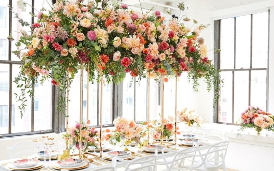 Floral arrangements hanging at the roof of an event space. 