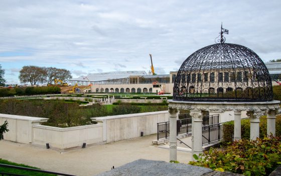 A scene at Longwood Gardens with a love temple in the foreground and a construction site in the background.