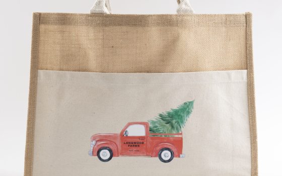 A jute totebag featuring a red pick up truck.