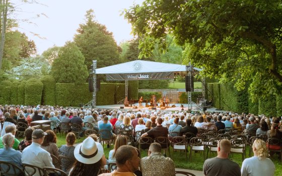 An outdoor concert being performed in the Open Air Theatre at Longwood Gardens.