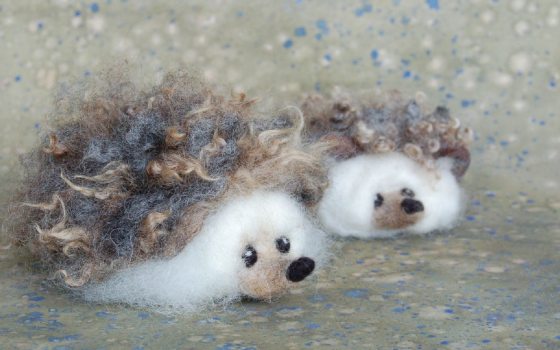 Two cutesy felt made hedgehogs.