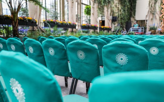 Rows of seating, set for a concert, inside the Longwood Gardens Conservatory.