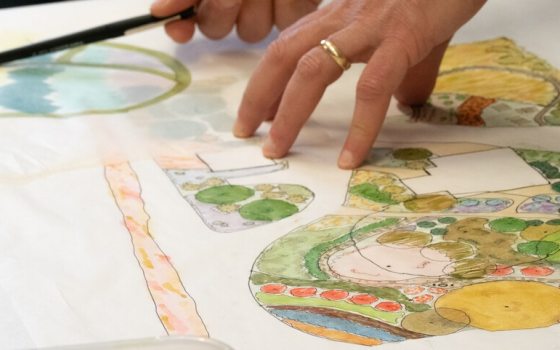 A person creating a landscape design plan.