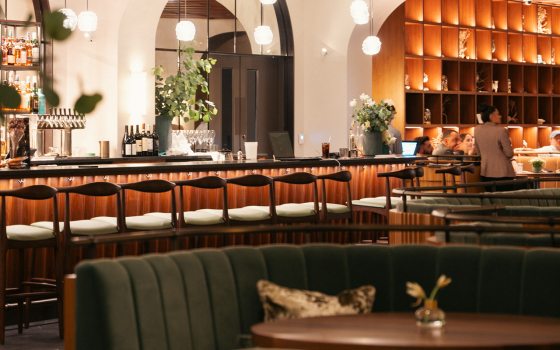 a row of chairs at a bar