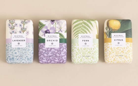 Four bars of soap in a line in botanical prints.
