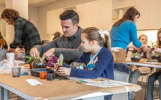 Father and daughter planting a terrarium 