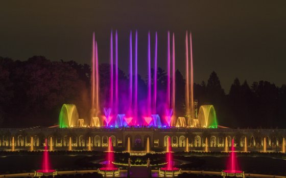 The Main Fountain Garden at Longwood with its fountains at night lit up in an array of colors.
