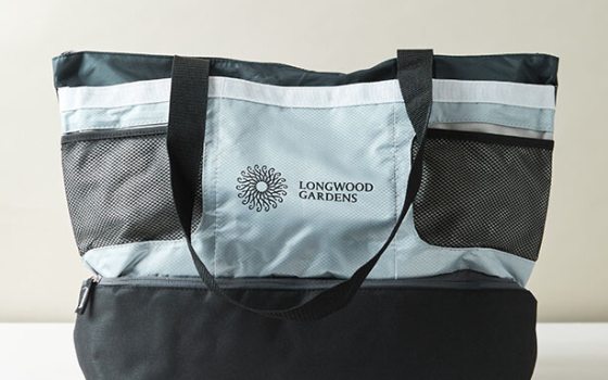 A black, gray and white tote bag featuring the Longwood Gardens logo.