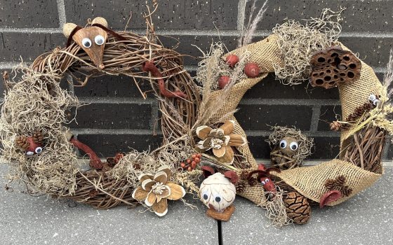 Two wreaths hand decorated with natural materials 