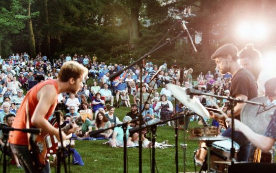 A concert performance on a large lawn.