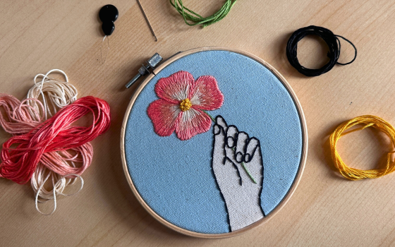 Embroidery by Lea Saccomanno including a hoop and embroidery thread.