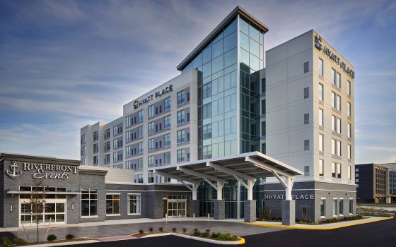 The exterior of a Hyatt hotel in daylight.