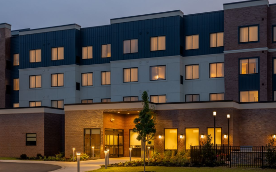The exterior of a Residence Inn hotel in twilight.
