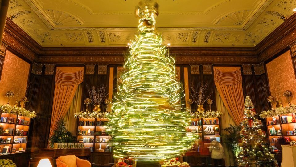 A spinning Chirstmas tree captured with a long-exposure making light trails in a circular motion