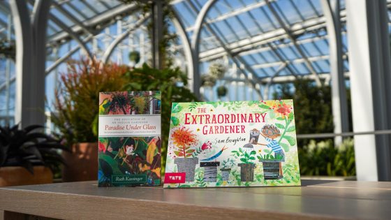 Two Community Read books are displayed on a table against a conservatory backdrop.