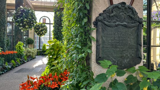 A bronze plaque with text in the Longwood Conservatory.
