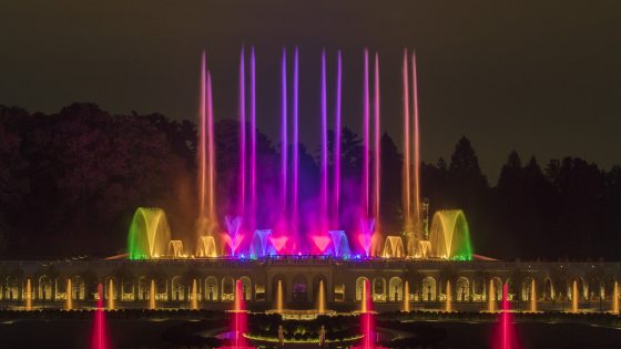 The Main Fountain Garden at Longwood with its fountains at night lit up in an array of colors.