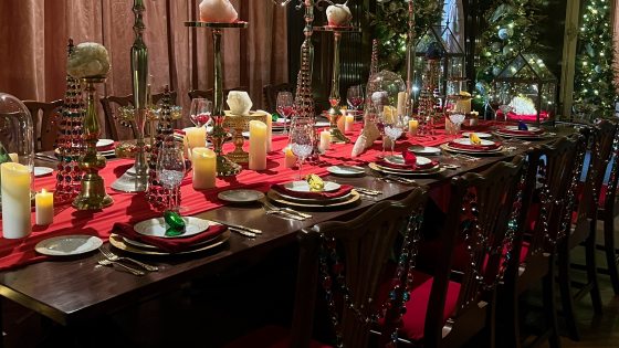 Diagonal shot of a lavishly decorated table, set for a holiday dinner, bedecked with minerals, gems, and jewels.