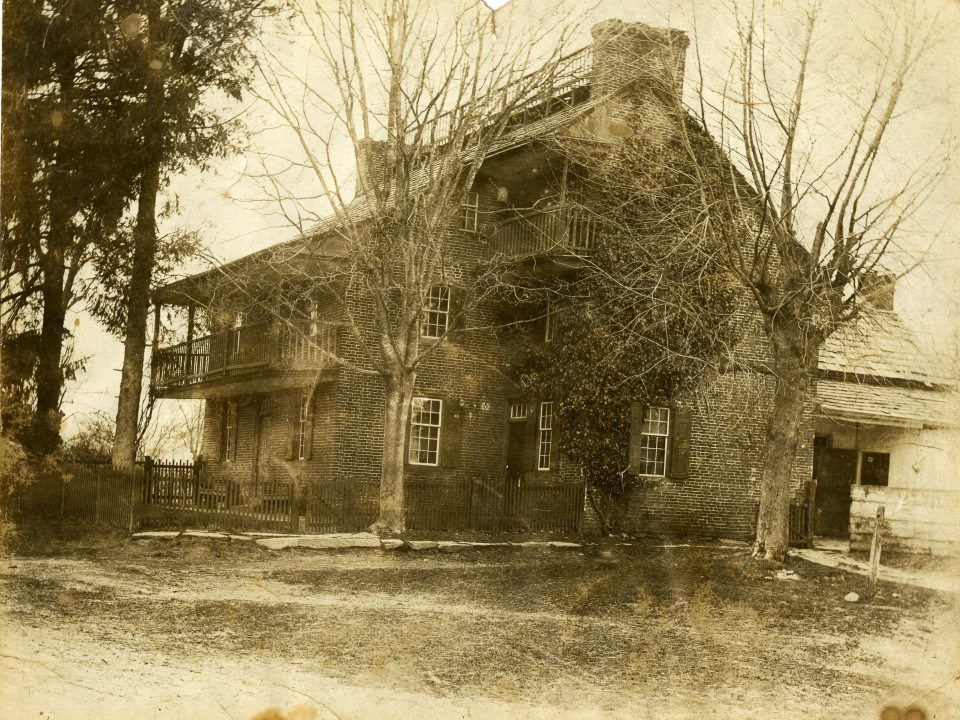 sepia tone image of an old stone house