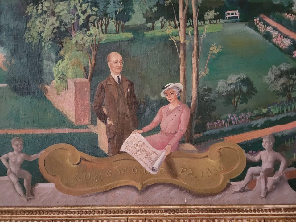 oil painting of two people sitting in a garden with a gold placque that reads Longwood PA 1936