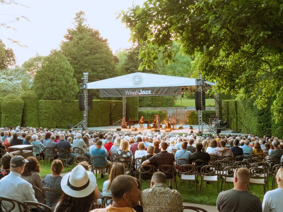 An outdoor concert being performed in the Open Air Theatre at Longwood Gardens.