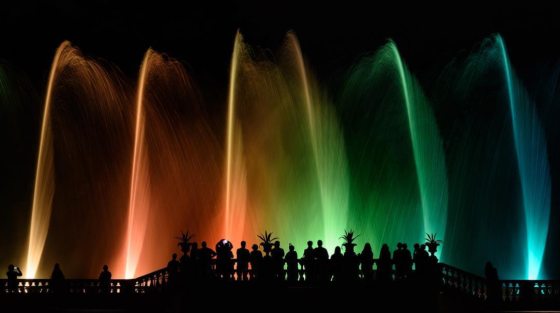 fountains illuminated in rainbow of colors 