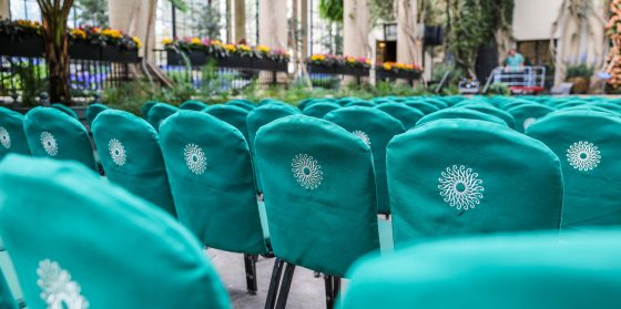 Rows of seating, set for a concert, inside the Longwood Gardens Conservatory.