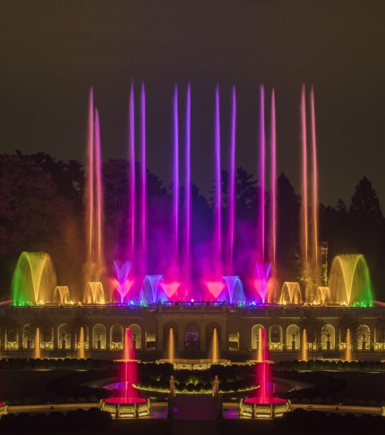 The Main Fountain Garden at Longwood with its fountains at night lit up in an array of colors.