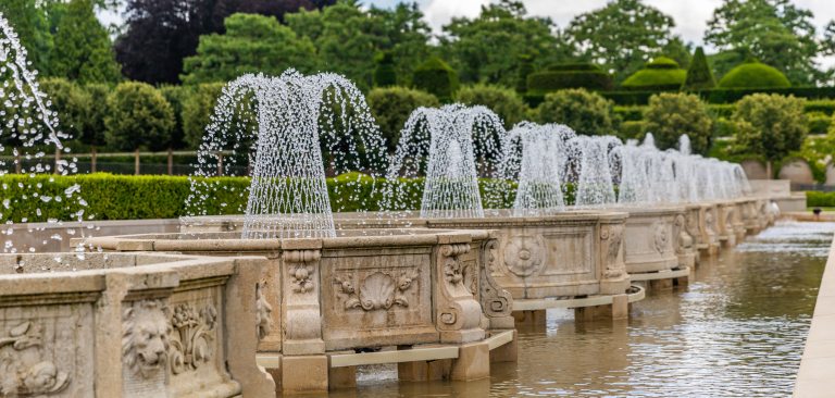 a row of fountains spraying water