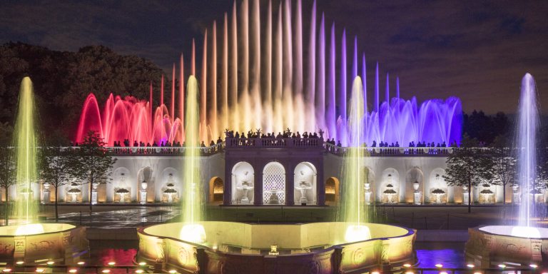 Night time fountains colored by pink, lime, and purple lights.